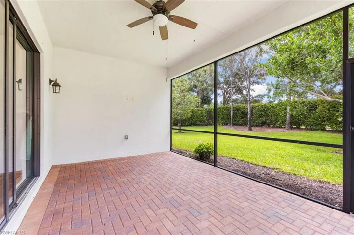 Unfurnished sunroom with ceiling fan