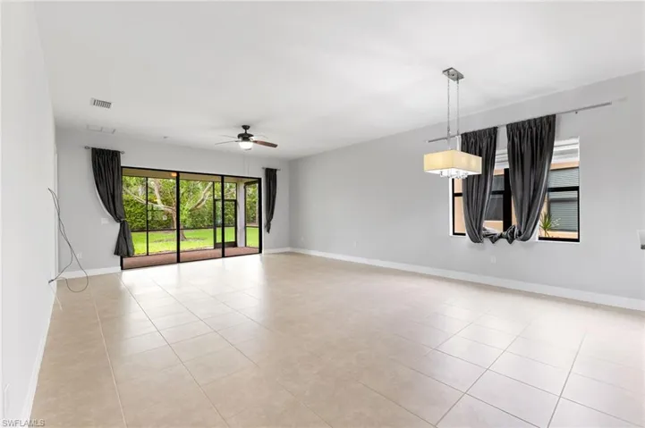Tiled empty room with ceiling fan