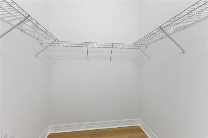 Spacious closet featuring hardwood / wood-style floors