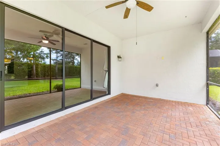 Unfurnished sunroom with ceiling fan