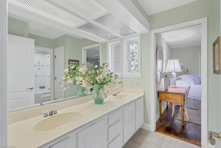 Bathroom with vanity, hardwood / wood-style floors, and toilet