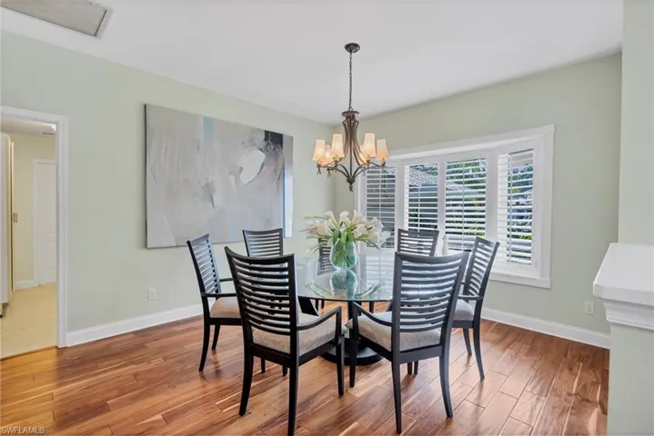 Dining space with a notable chandelier & bay window