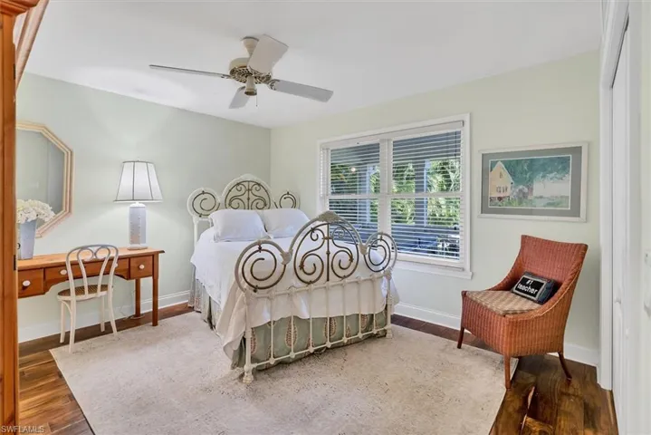 Bedroom with ceiling fan and hardwood / wood-style floors