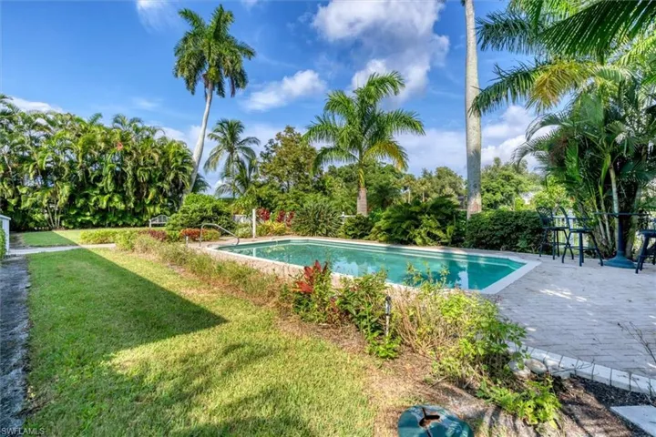 View of swimming pool with a lawn