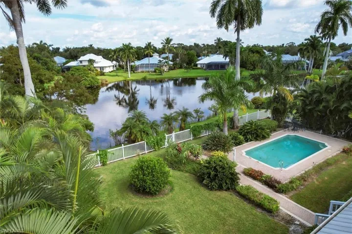 View of pool featuring a water view and a yard