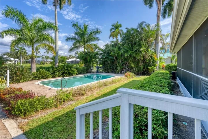 View of swimming pool featuring a lawn