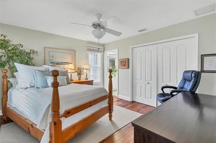 Bedroom with ceiling fan, a closet, and hardwood / wood-style floors