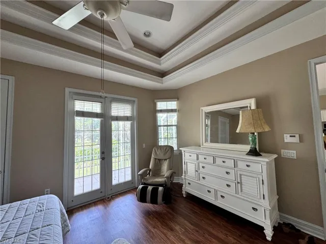 Master bedroom with french doors to the lanai overlooking the pool