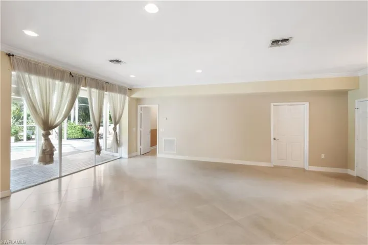 Unfurnished downstairs living area, crown molding, tile