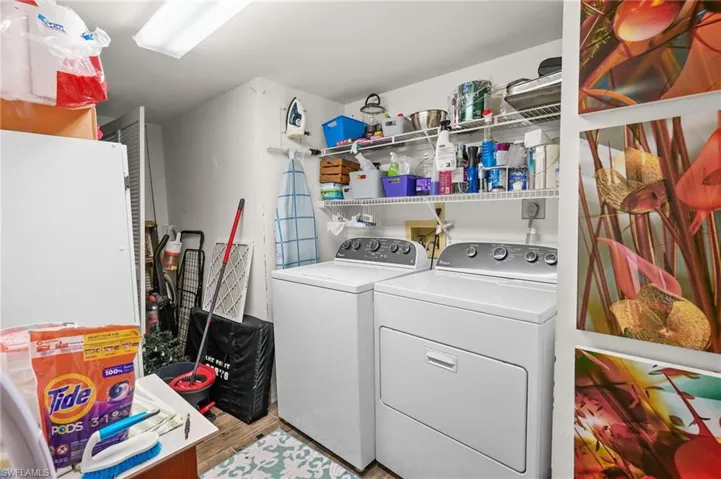 Laundry area featuring washer and dryer and light wood-style flooring