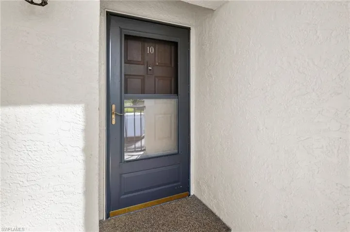 Property entrance with stucco siding