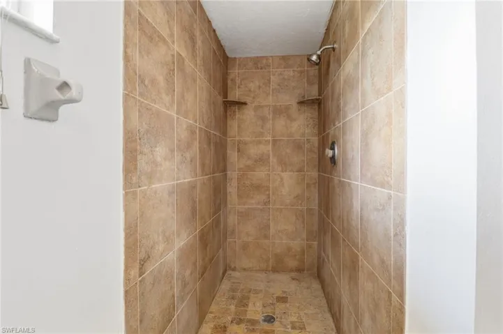 Full bath with a tile shower