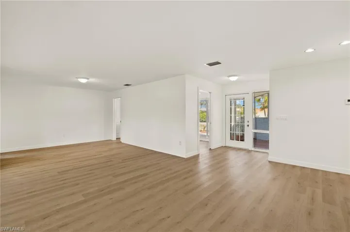 Spare room featuring light wood-style floors, recessed lighting, and french doors
