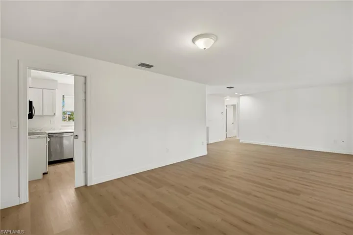 Unfurnished room featuring light wood-type flooring and baseboards