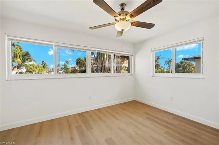 Spare room featuring light wood-type flooring and a ceiling fan