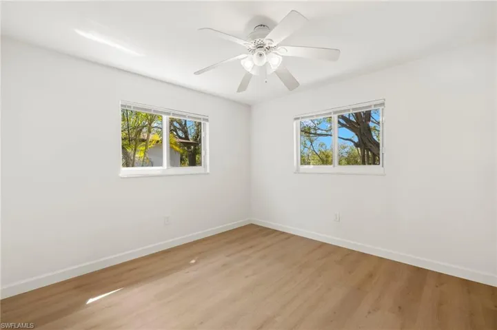 Unfurnished room featuring wood finished floors and a ceiling fan