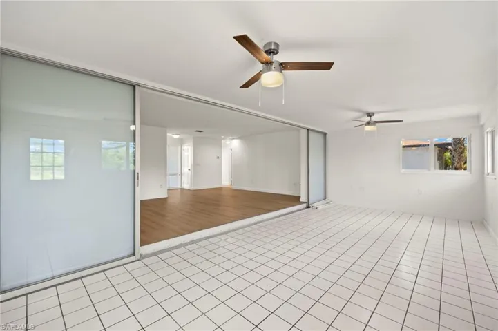 Spare room featuring a ceiling fan and light tile patterned floors