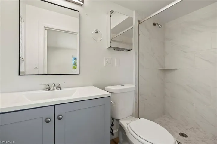 Full bath with vanity and a shower stall