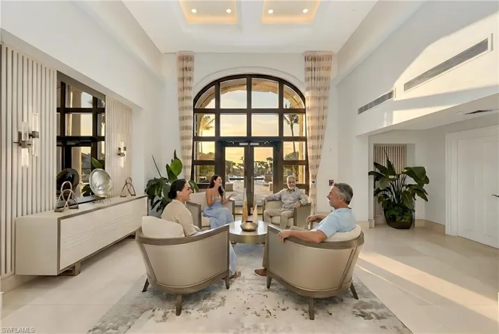Living area featuring french doors, a high ceiling, and recessed lighting