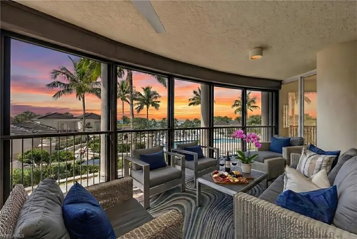 Sunroom with a textured ceiling and floor to ceiling windows