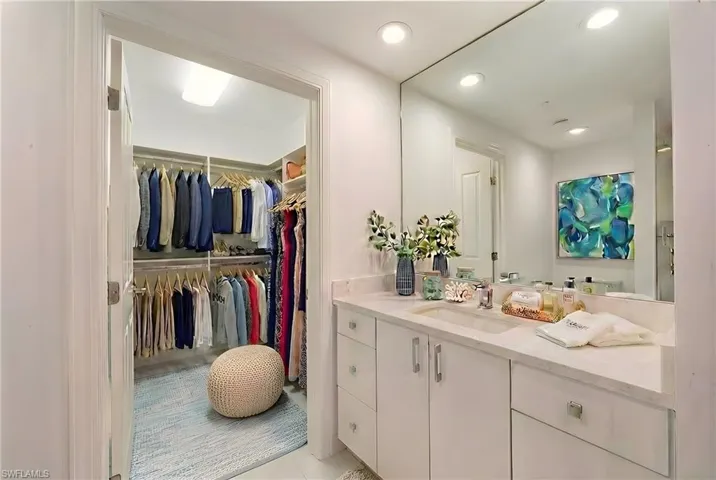 Bathroom featuring vanity, a spacious closet, and recessed lighting