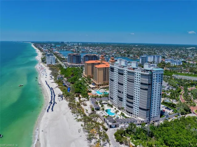 View of urban area with extended coastline and a pool