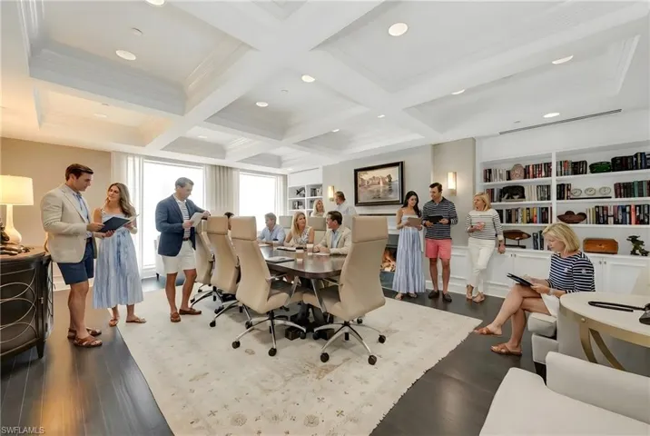 Office space featuring coffered ceiling, ornamental molding, recessed lighting, and a fireplace