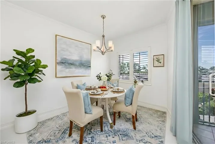 Dining space with ornamental molding and a chandelier