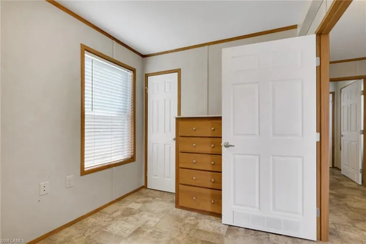 Unfurnished bedroom featuring ornamental molding and baseboards