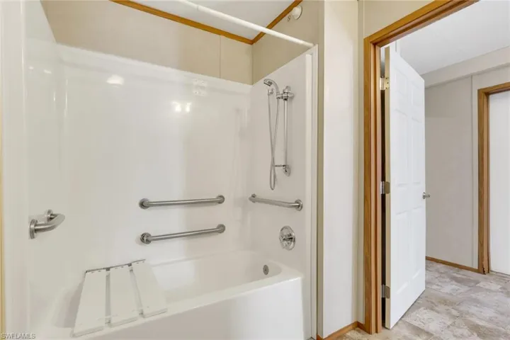 Full bath featuring bathing tub / shower combination and baseboards