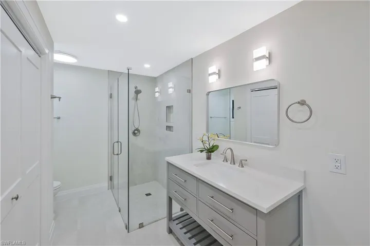 Full bathroom featuring vanity, a shower stall, and recessed lighting