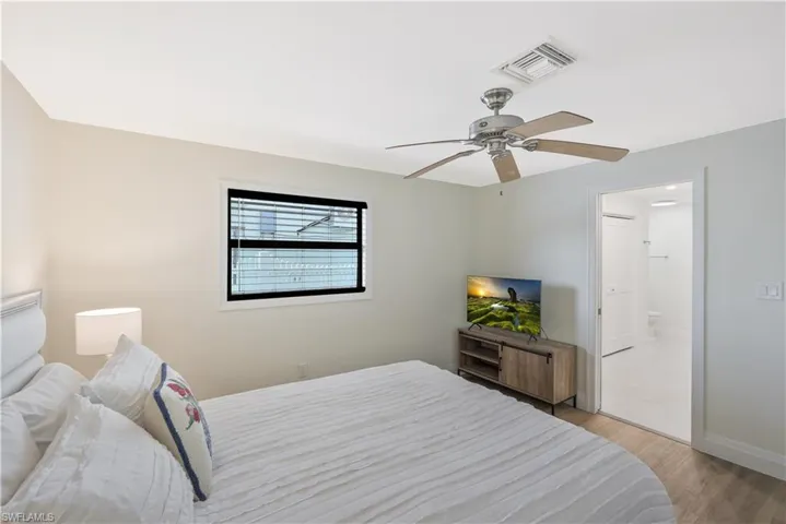 Bedroom with light wood-style floors and ceiling fan