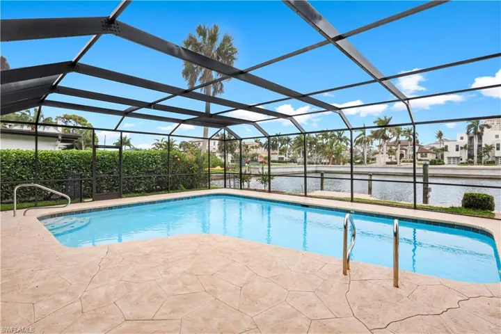 Outdoor pool featuring a sunroom, a lanai, a water view, a patio, and a residential view