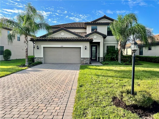 View of front of home featuring a garage and a front lawn
