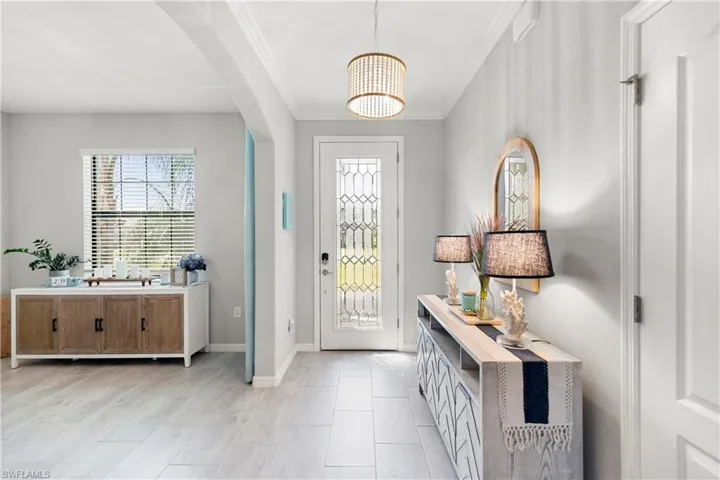 Foyer entrance with upgraded ceramic tile and crown molding.