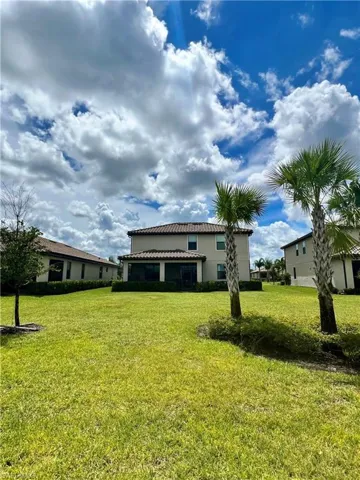 Spacious backyard overlooking grass preserve area.