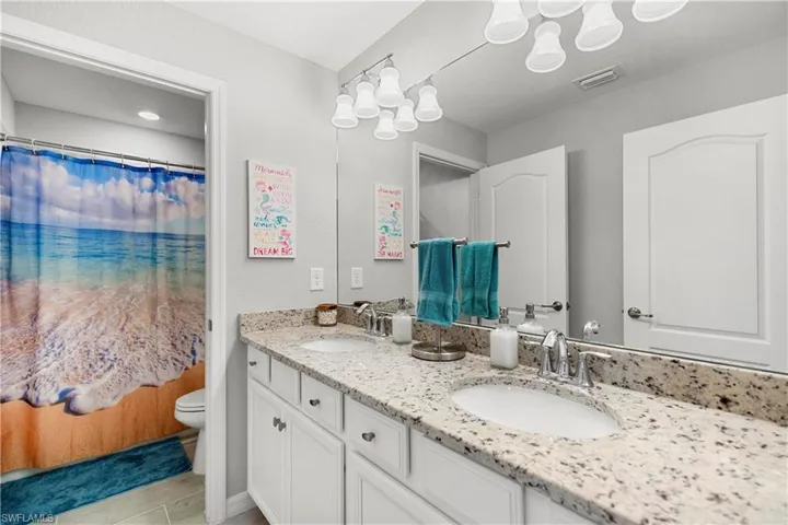 Bathroom with tub and large double vanity.