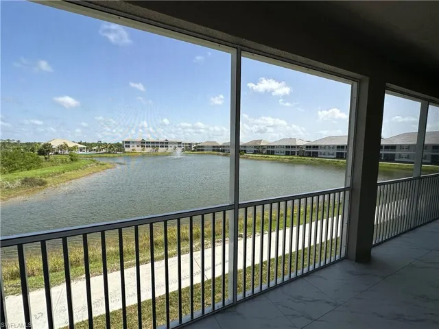 Unfurnished sunroom featuring a water view