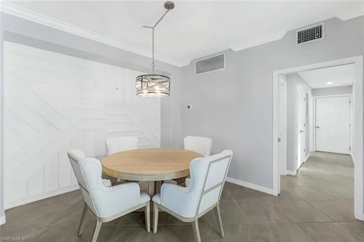 Dining area features a stunning decorative wall that is sure to impress.