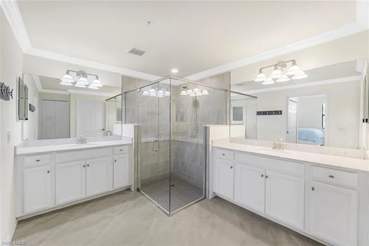 Primary bath features a large walk-in shower and dual sinks.