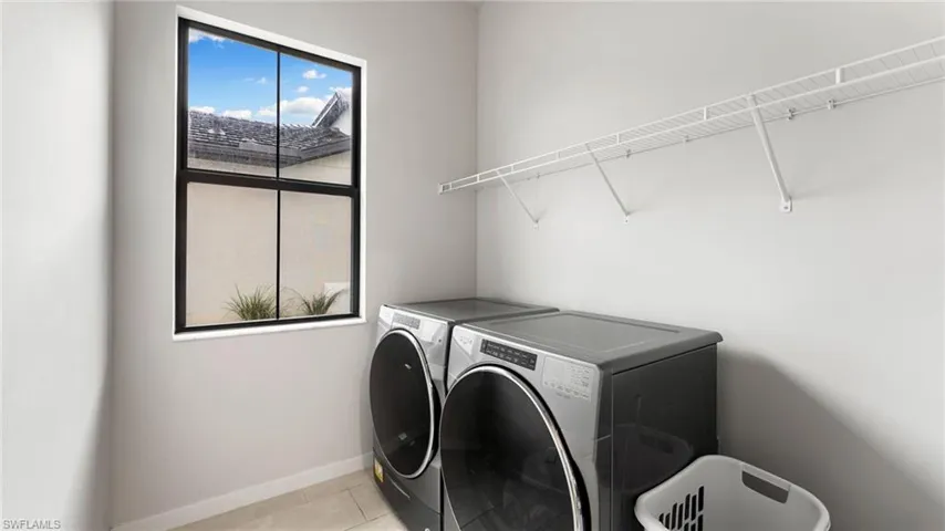 In Home utility room with lovely window and storage shelf!