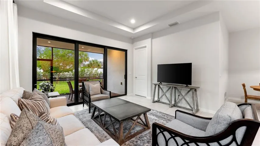 Door leading to the primary bedroom with views of the lush green backyard!