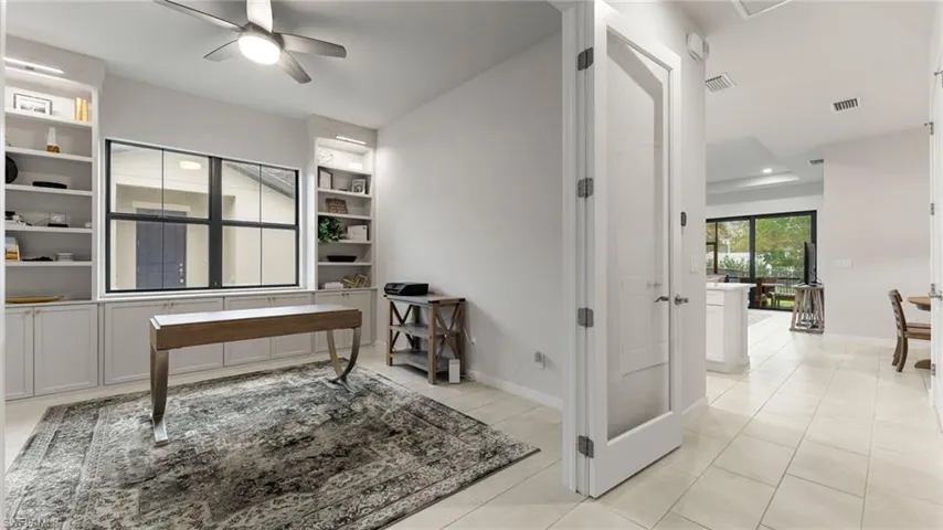 French doors leading to the den/office space with custom built-ins!