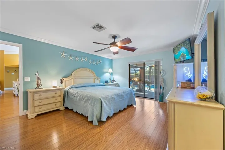 Bedroom with crown molding, ceiling fan, visible vents, access to exterior, and light wood-type flooring