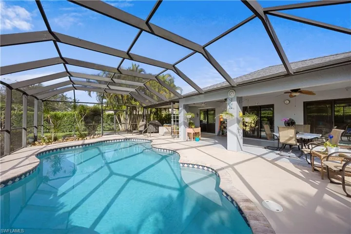 Outdoor pool with ceiling fan and a patio area
