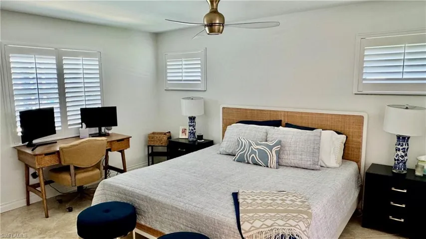 Bedroom featuring a ceiling fan and a desk