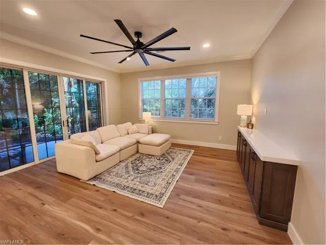 Living room featuring ceiling fan, light wood finished floors, ornamental molding, and recessed lighting