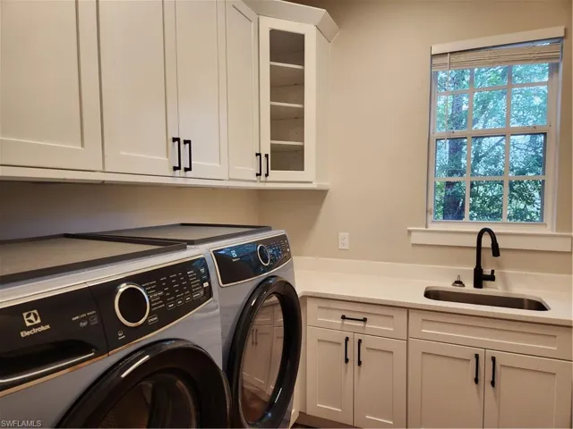 Laundry area with cabinet space and independent washer and dryer