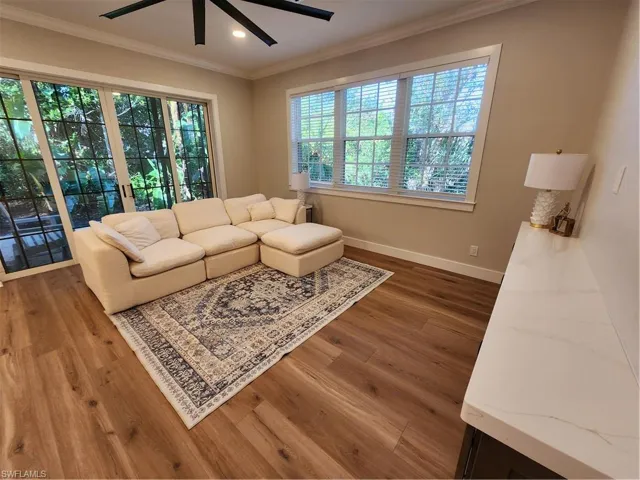 Living area featuring a ceiling fan, dark wood finished floors, ornamental molding, and recessed lighting