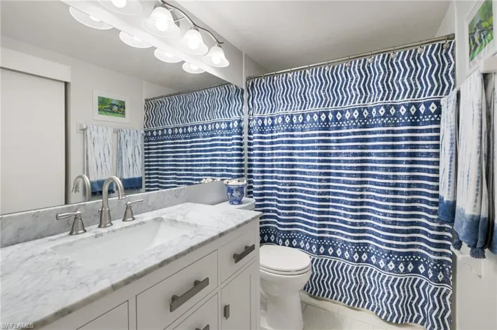 Bathroom with vanity, tile patterned flooring, and toilet